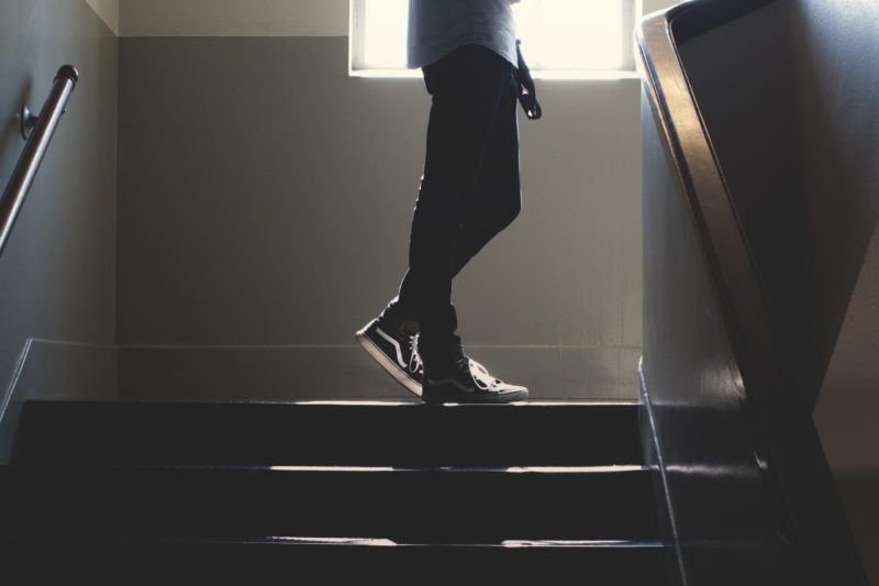 Kid walking up dark stairs