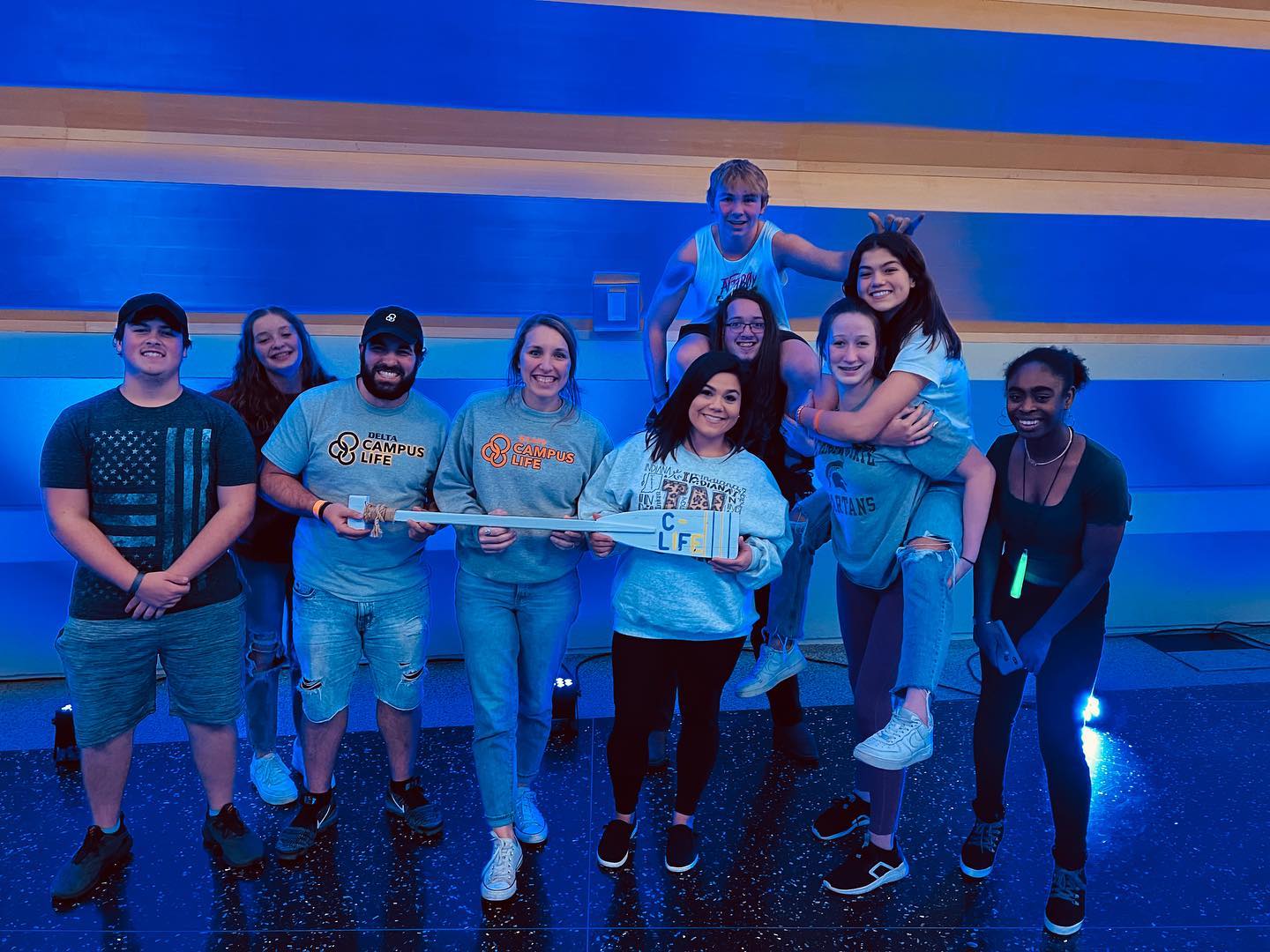 group posing together in a blacklight