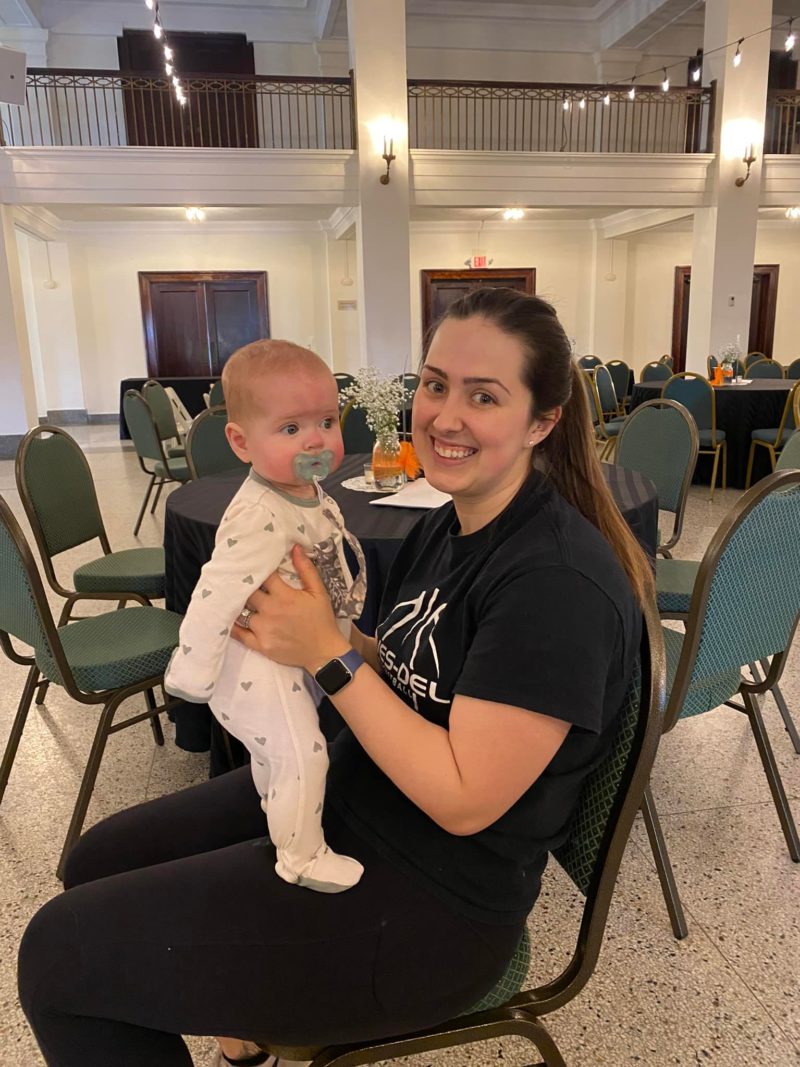 alumni holding her baby