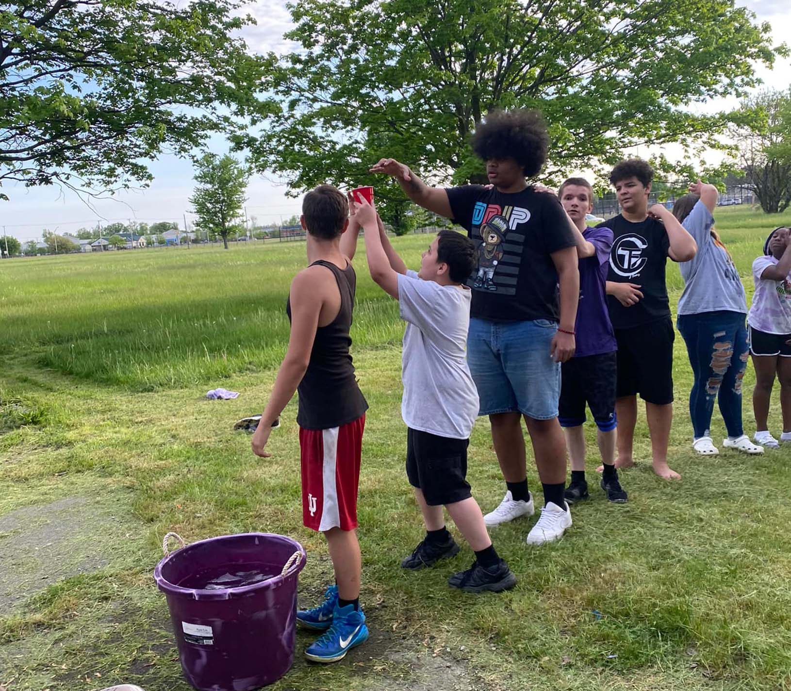kids passing water at a yfc event