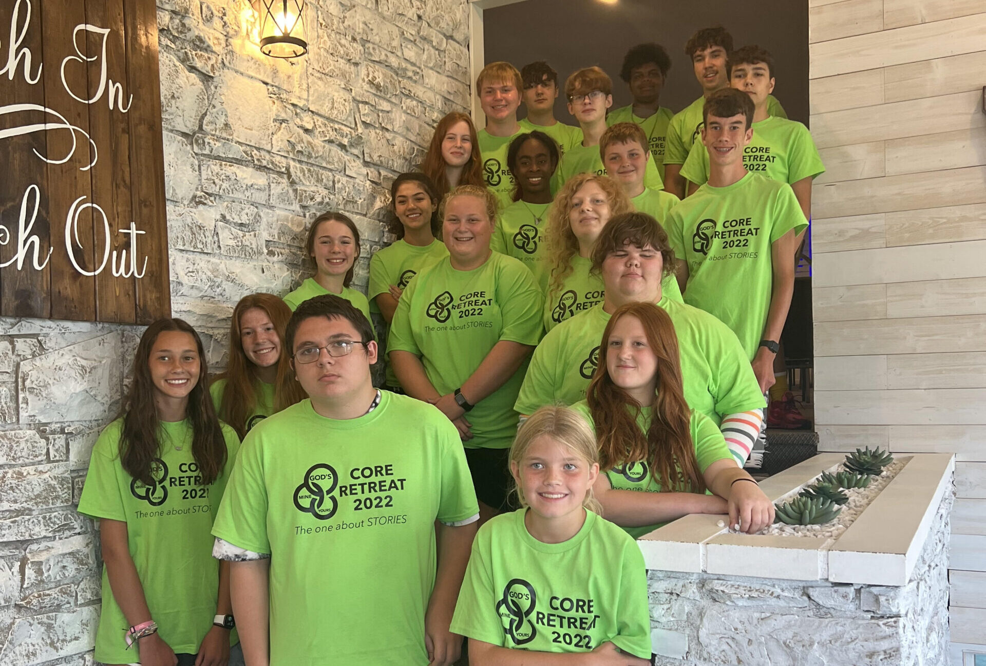 youth group students from muncie area youth for christ standing on stairs going up